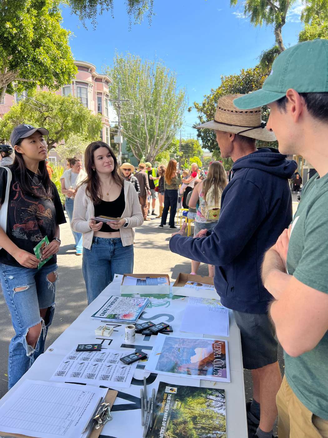 Sierra Club volunteers tabling at WiggleFest 2026 with the Civic Joy Fund Green Streets Guild cafe-district street garden