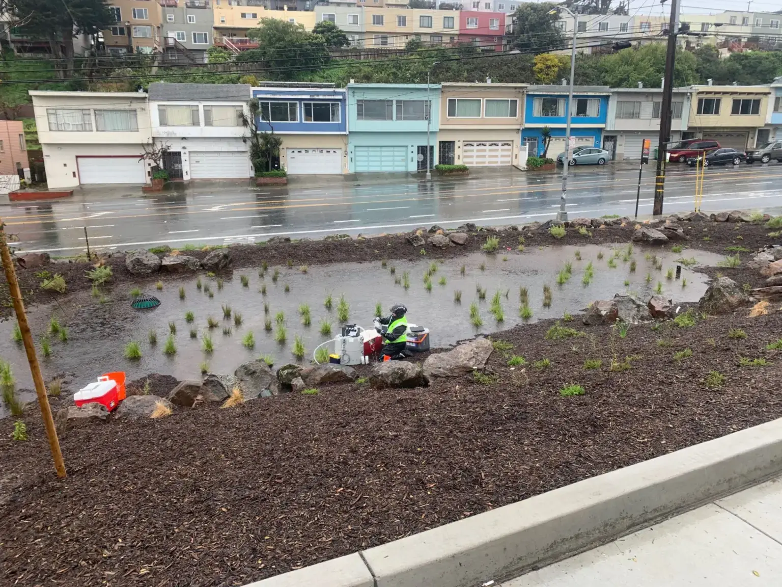 Researchers collecting stormwater samples from a rain garden in the Crocker-Amazon neighborhood of San Francisco